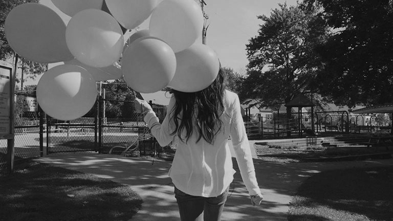 a woman with baloons